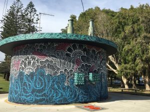 An original way to display indigenous art and disguise a storage area in Burleigh. The design and colour seem to have derived from the dragon lizard.